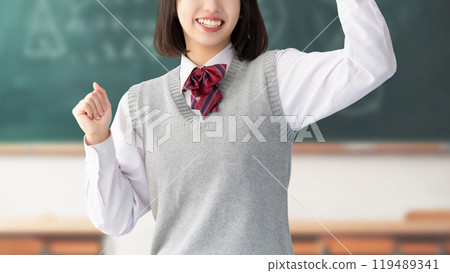 Exam takers and female high school students in uniforms making a fist pump Exam takers and female high school students in uniforms making a fist pump 119489341