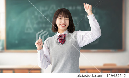 Exam takers and female high school students in uniforms making a fist pump 119489342