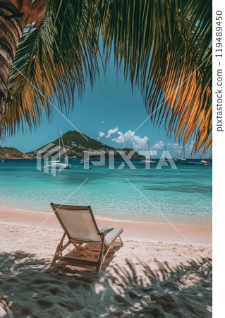 Relaxing beachside view with a wooden lounge chair and distant sailboats under a blue sky 119489450