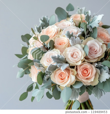 Elegant bouquet of soft pink and cream roses with eucalyptus leaves arranged for special occasions 119489453
