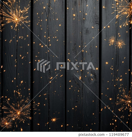 Sparks flying across a wooden surface during a celebration at night with a dark background 119489677