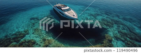 A luxury yacht cruises through clear blue waters on a sunny day in a tropical location 119490496
