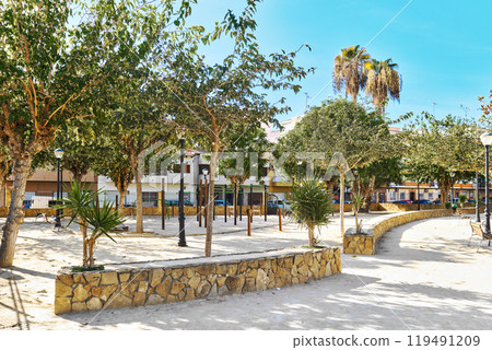 Peaceful park in residential neighborhood, with well-maintained trees Peaceful park in residential neighborhood, with well-maintained trees 119491209