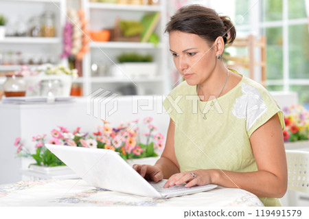 A young emotional girl uses a laptop at home 119491579