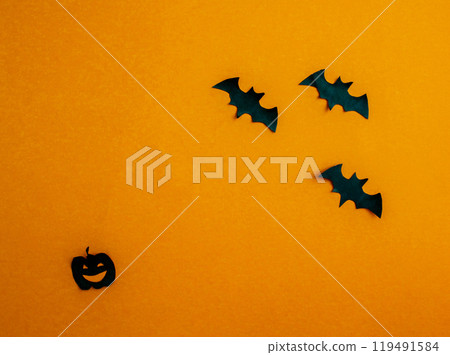 Halloween background, paper black bats and pumpkin on orange background. Halloween background, paper black bats and pumpkin on orange background. 119491584
