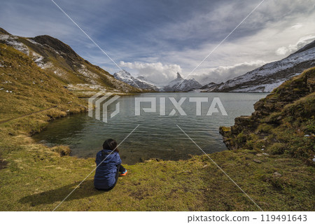 Grindelwald First Switzerland nature landscape at Bachalpsee Lake (Bachsee) with woman tourist Grindelwald First Switzerland nature landscape at Bachalpsee Lake (Bachsee) with woman tourist 119491643