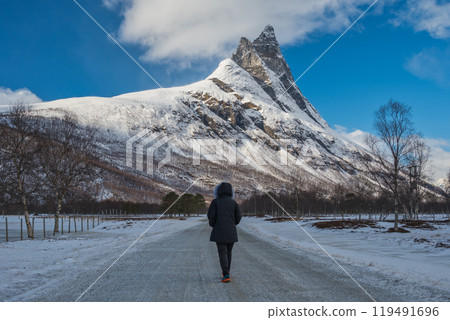 Tromso Norway woman tourist with winter nature landscape at Otertinden mountain in Signaldalen Tromso Norway woman tourist with winter nature landscape at Otertinden mountain in Signaldalen 119491696