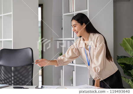 Professional Female Accountant Analyzing Financial Management Documents in Modern Office Environment 119493640