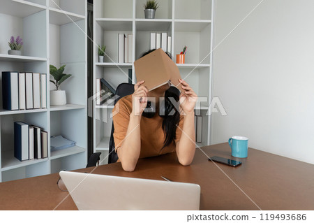Young Woman Feeling Stressed from Studying Online at Home with Laptop and Books in Modern Workspace 119493686