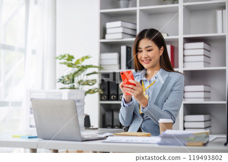Professional Female Accountant Contacting Customer via Phone in Modern Office Setting Professional Female Accountant Contacting Customer via Phone in Modern Office Setting 119493802