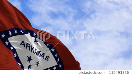 Arkansas state flag waving in the wind on a clear day 119493826