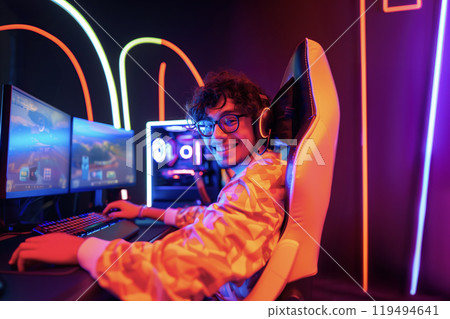 professional Esports streamer with glasses and headphones smiling and looking at the camera 119494641