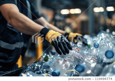 Worker Sorting Plastic Bottles in Recycling Plant 119494774