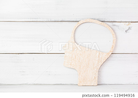 Abstract Wooden Silhouette of a Head with Open Mind Concept on White Background 119494916