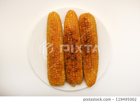 Fried corn on a white background. Delicious corn. Delicious toasted corn cobs. Fried corn on a white background. Delicious corn. Delicious toasted corn cobs. 119495002