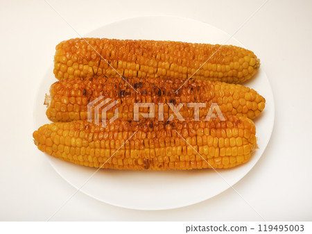Fried corn on a white background. Delicious corn. Delicious toasted corn cobs. Fried corn on a white background. Delicious corn. Delicious toasted corn cobs. 119495003