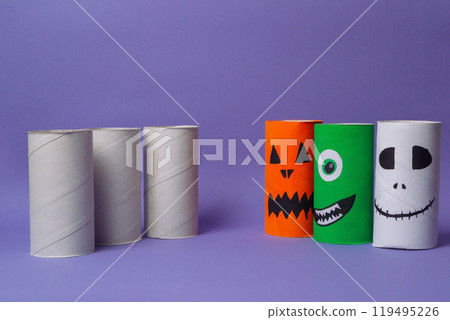 A group of paper tubes with Halloween faces drawn on them 119495226