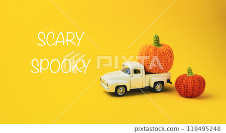 White truck is carrying two pumpkins White truck is carrying two pumpkins 119495248