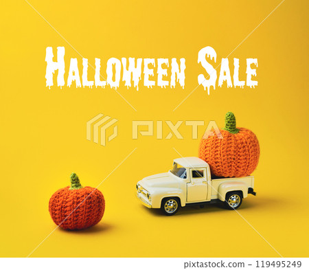 White truck is carrying two orange pumpkins White truck is carrying two orange pumpkins 119495249