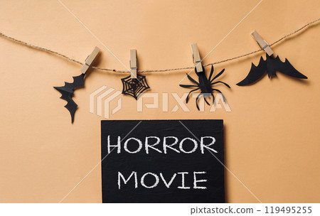 Blackboard with a spider, bat, and a black and white skull on it Blackboard with a spider, bat, and a black and white skull on it 119495255