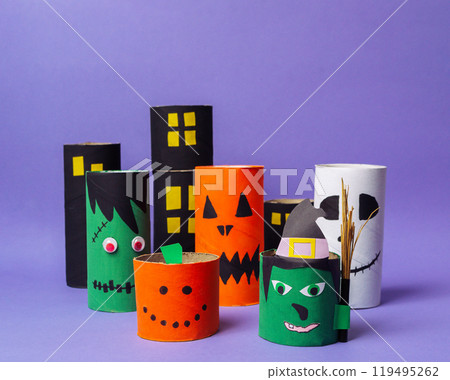 Group of Halloween-themed paper tubes with faces drawn on them 119495262