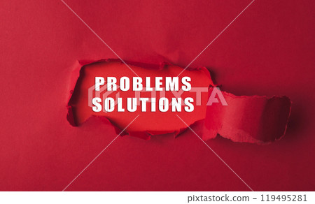 Red torn paper revealing the words problems solutions on a bold red background 119495281