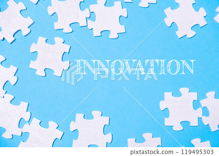 Puzzle pieces with innovation text on a blue background 119495303