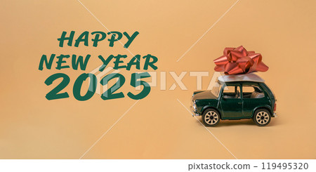 A green toy car with a red bow on top of it A green toy car with a red bow on top of it 119495320
