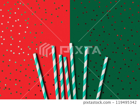 A green and red background with a row of straws on it 119495342