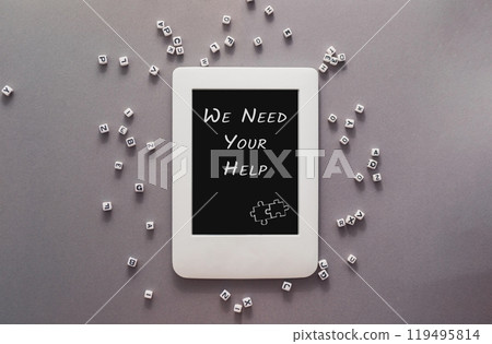 A white tablet with the words we need your help written on it A white tablet with the words we need your help written on it 119495814