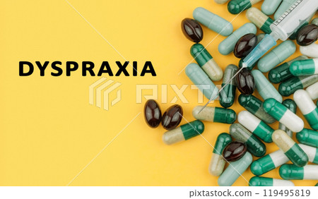 A bunch of pills with a syringe on top of them 119495819
