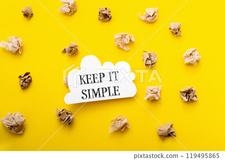 Keep it simple is written in bold black text on a bright yellow background 119495865
