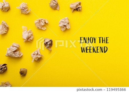 A yellow background with a pile of crumpled paper on it 119495866