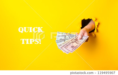 Hand holding a stack of money with the words Quick Tips written below it Hand holding a stack of money with the words Quick Tips written below it 119495907
