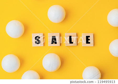 Yellow background with white balls and a word Sale written in black letters 119495913