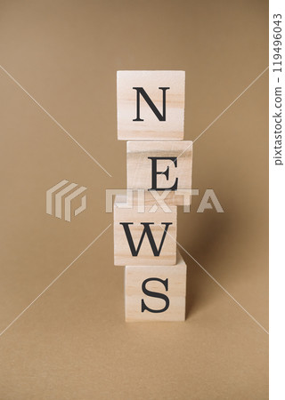 A stack of wooden blocks spell out the word news 119496043