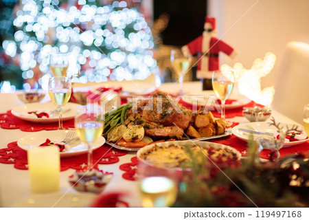 Christmas dinner at fire place and Xmas tree. 119497168