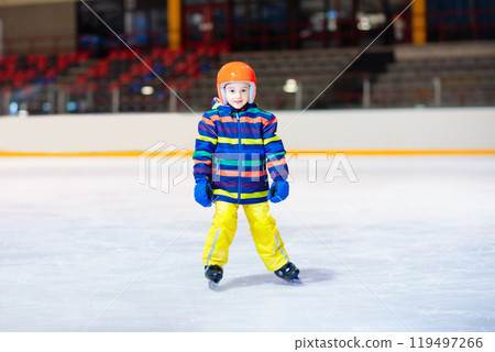 Child skating on indoor ice rink. Kids skate. 119497266