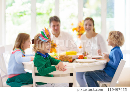 Family with kids at Thanksgiving dinner. Turkey. Family with kids at Thanksgiving dinner. Turkey. 119497455