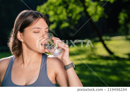 Future mother drinking water in park during pregnancy fitness workout Future mother drinking water in park during pregnancy fitness workout 119498284