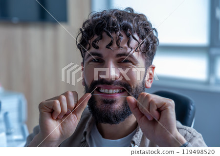 Male with using dental floss doing daily oral hygiene routine Male with using dental floss doing daily oral hygiene routine 119498520