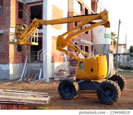 Construction lift working on a building project at a construction site on a sunny day 119498610
