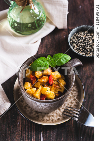 White bread pudding with egg, cheese and pepper in a cup on the table vertical view White bread pudding with egg, cheese and pepper in a cup on the table vertical view 119498731