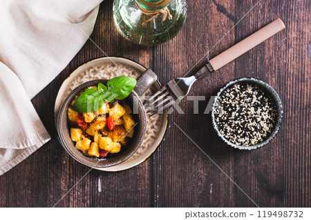 Bread pudding with egg, pepper and basil in a cup on the table top view 119498732