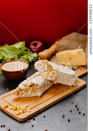Delicious grilled wrap with chicken, corn, and creamy filling, perfect for lunch or a quick snack 119499613