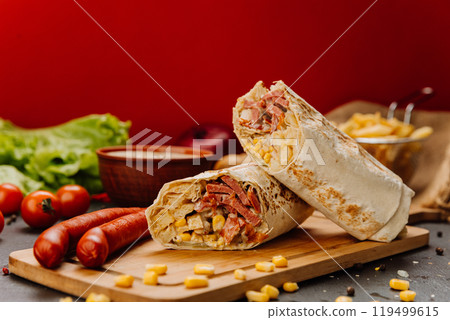 Grilled wrap filled with sausage, corn, and melted cheese. Hearty meal or street food craving 119499615