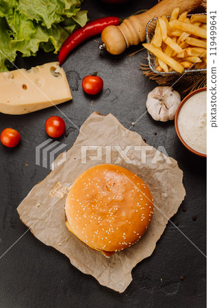 Top-down view of burger on kraft paper with fresh ingredients, food menus and marketing campaigns Top-down view of burger on kraft paper with fresh ingredients, food menus and marketing campaigns 119499641