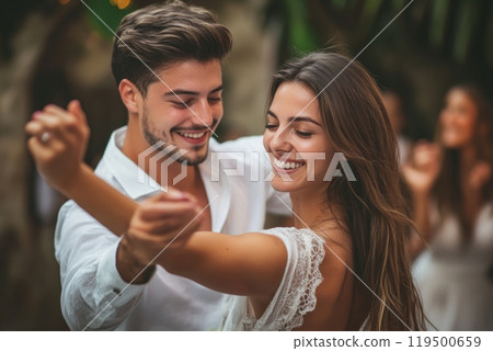 Happy couple smiling and dancing together at a party 119500659