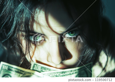 Woman hiding her face with intense green eyes and dollar bills 119500712