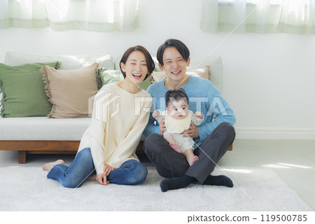 A family relaxing in the living room A family relaxing in the living room 119500785